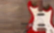 Electric guitar with pliers and strings on wooden background.jpg