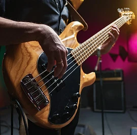 bass guitar in hands of musician.jpg