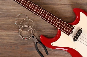 Electric guitar with pliers and strings on wooden background_edited.jpg