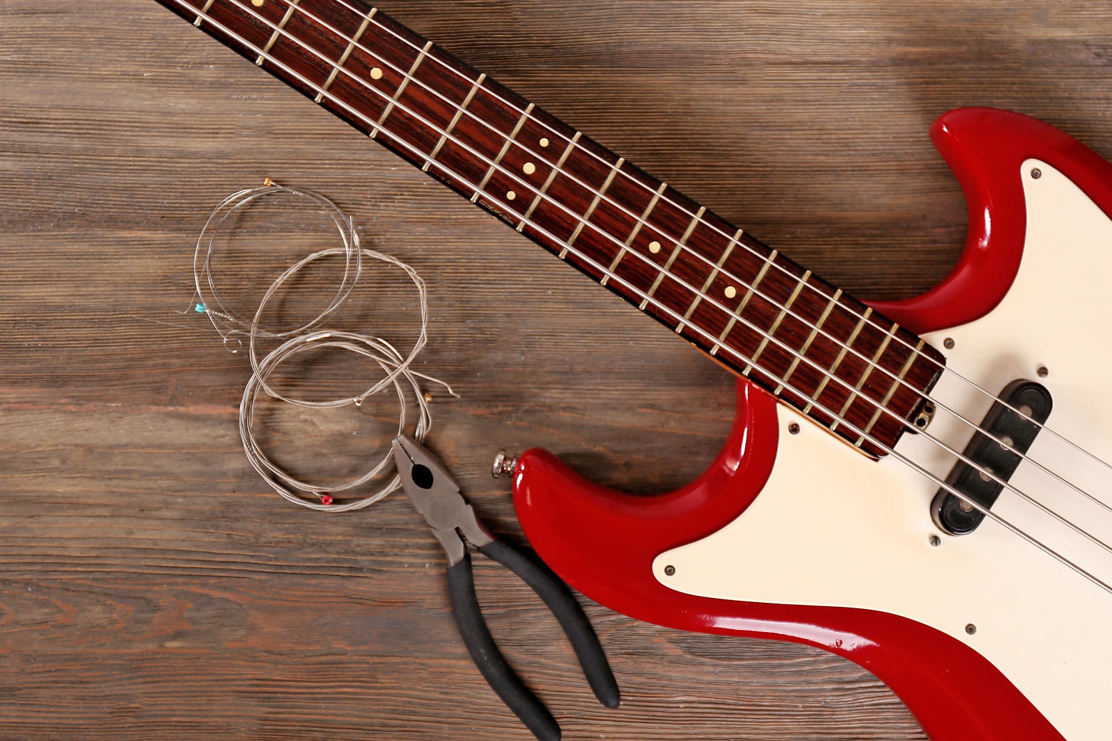 Electric guitar with pliers and strings on wooden background_edited.jpg