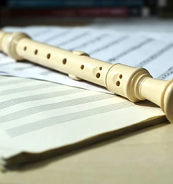 Plastic flute on music sheets.jpg